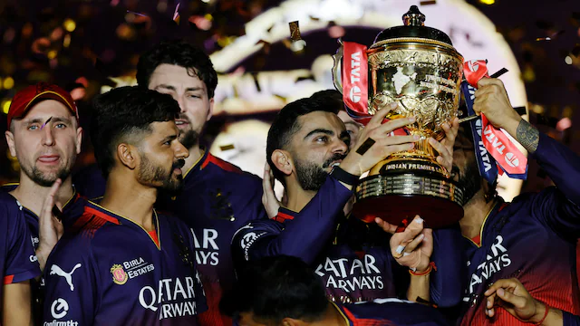 Virat Kohli takes a look at the IPL trophy after finally ending his long wait. (BCCI Photo)
